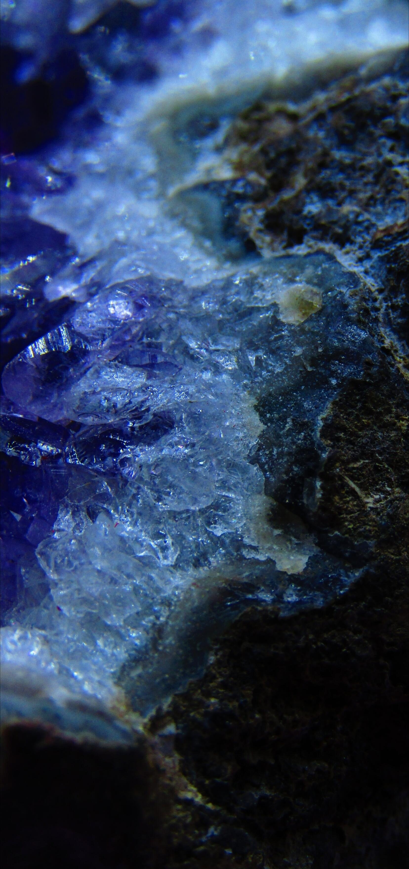 Amethyst purple-blue gemstone geode rock segment closeup with metal inclusion. by Demasc1