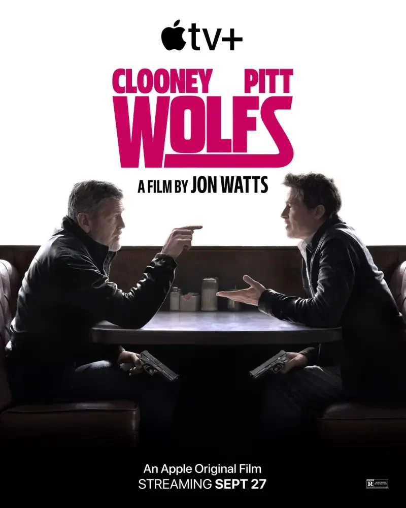 A cinematic poster for Wolfs (2024), featuring George Clooney and Brad Pitt in an intense conversation, set against a dark background. Directed by Jon Watts, streaming on Apple TV+.