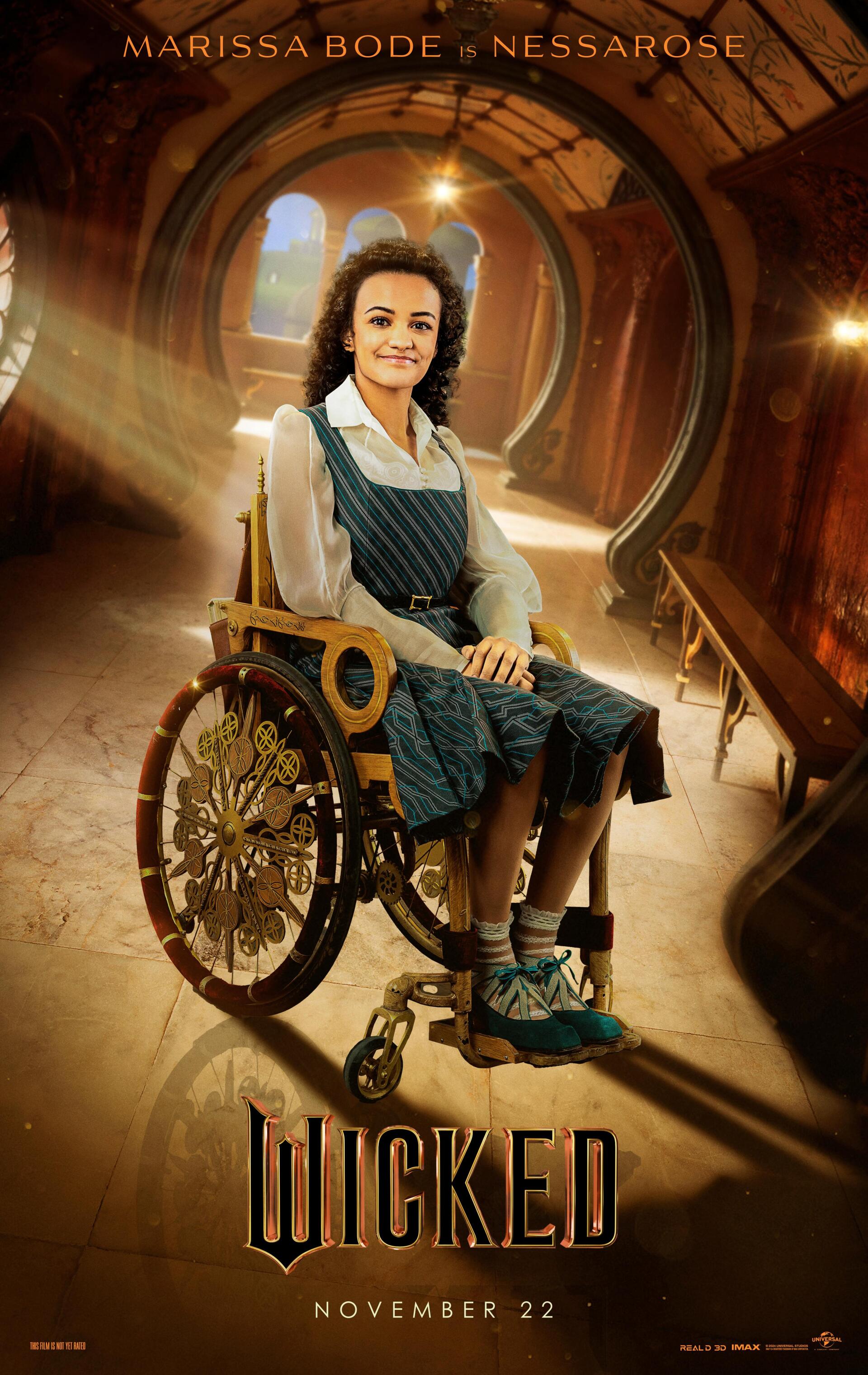 A promotional image for the movie Wicked features Marissa Bode as Nessarose, seated in a wheelchair with a thoughtful expression, set against a warm, illuminated background.