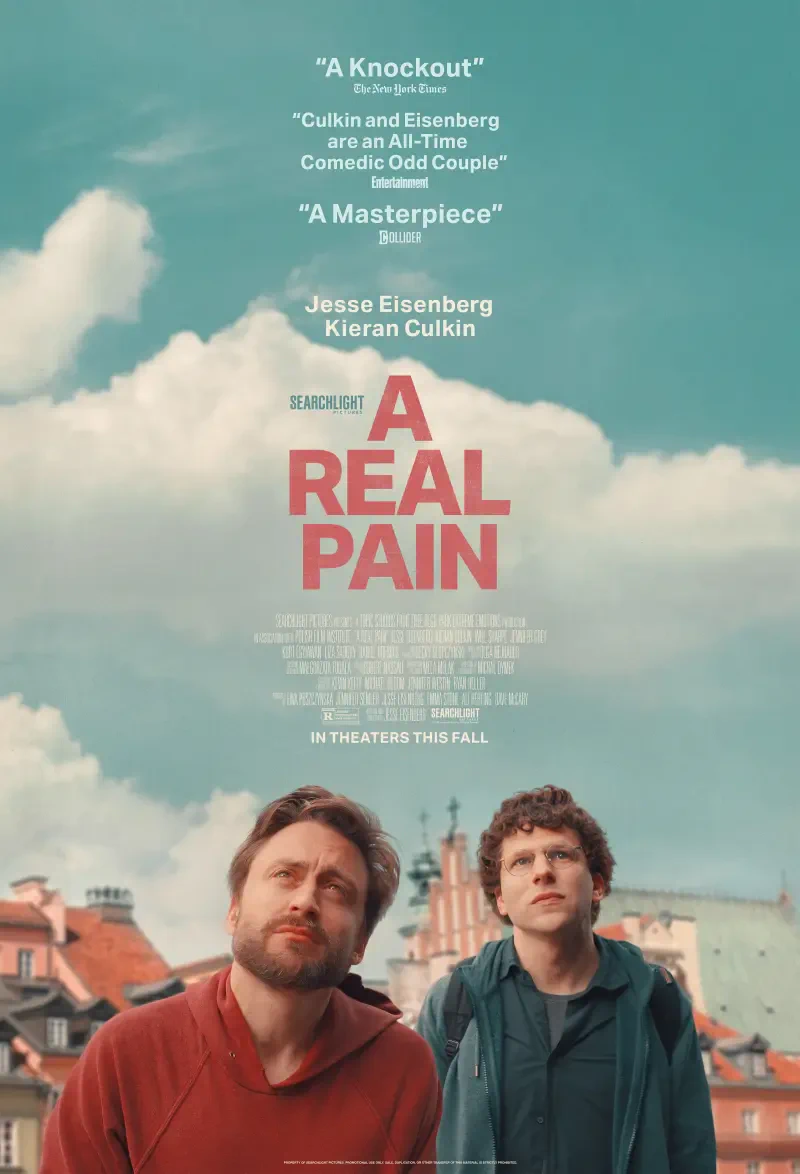 Two men look up thoughtfully in the film poster for A Real Pain, featuring Kieran Culkin and Jesse Eisenberg, with quotes praising their performances and the movie's release in theaters this fall.