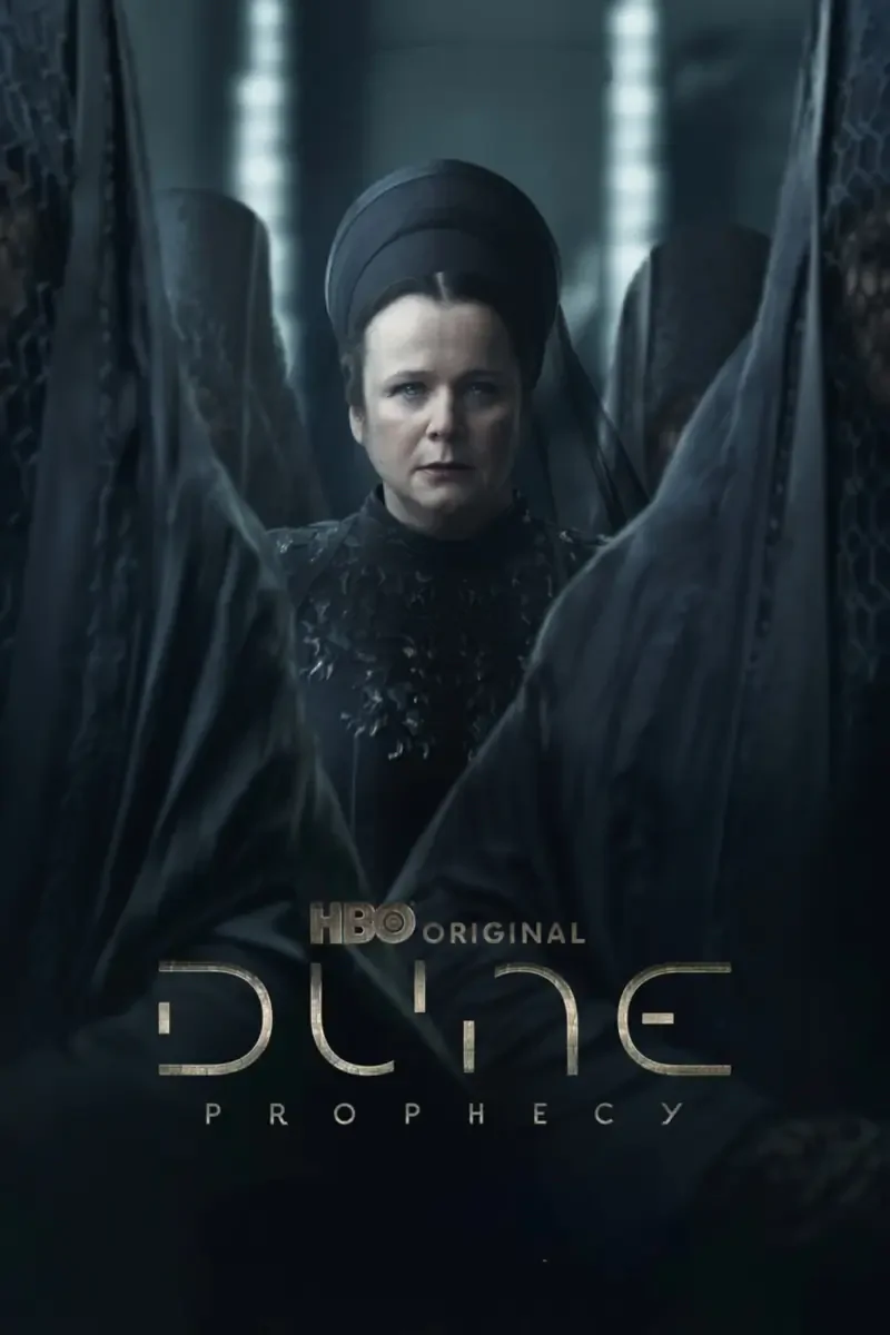A dramatic scene from the HBO original series Dune: Prophecy, featuring a central character surrounded by figures in dark cloaks, evoking a sense of mystery and tension.