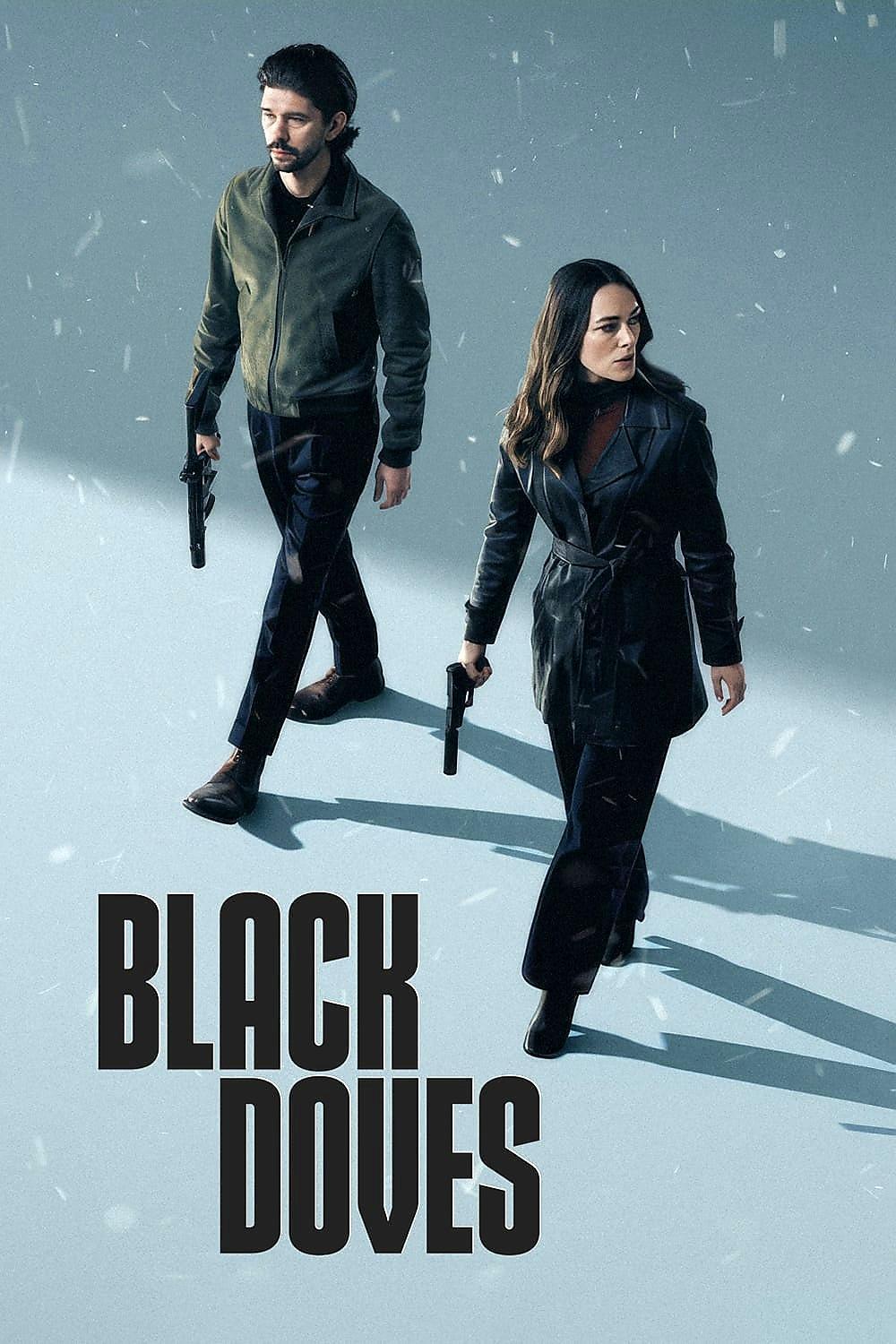 Two characters from the TV show *Black Doves* walk confidently through a snowy setting, each holding a gun, conveying a sense of tension and determination.