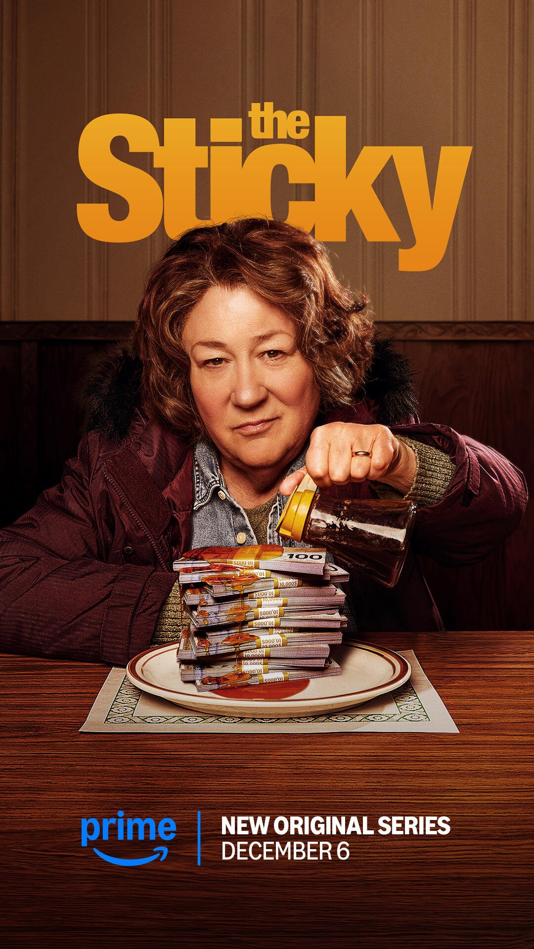 A woman pours syrup over a stack of pancakes in a promotional image for the TV show The Sticky, premiering December 6 on Prime Video.