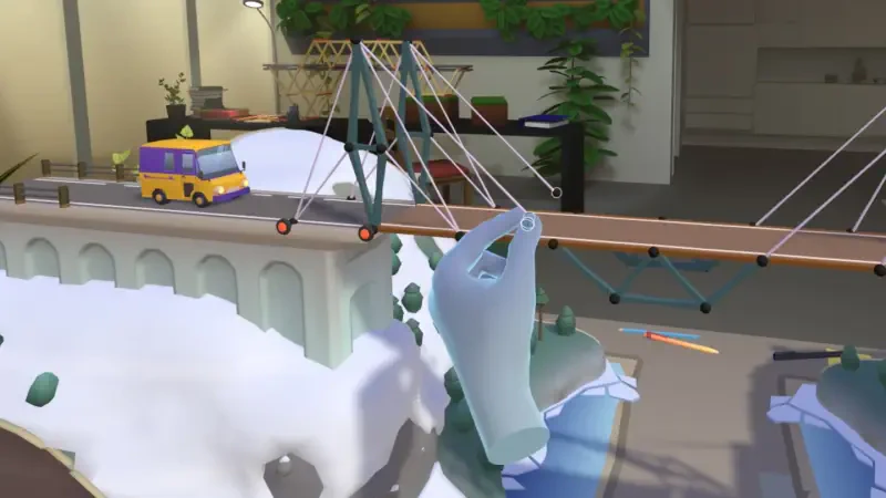 A playful scene from Bridge Constructor Studio, showcasing a suspension bridge over a snowy landscape with a yellow vehicle crossing, surrounded by greenery and indoor elements.