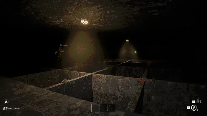 A dark, underground setting from the video game KLETKA, featuring shadows, illuminated areas, and rough, unfinished surfaces that create a sense of mystery and tension.