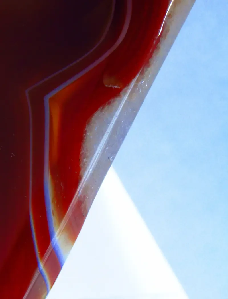  Polished red orange carnelian geode rock segment closeup.