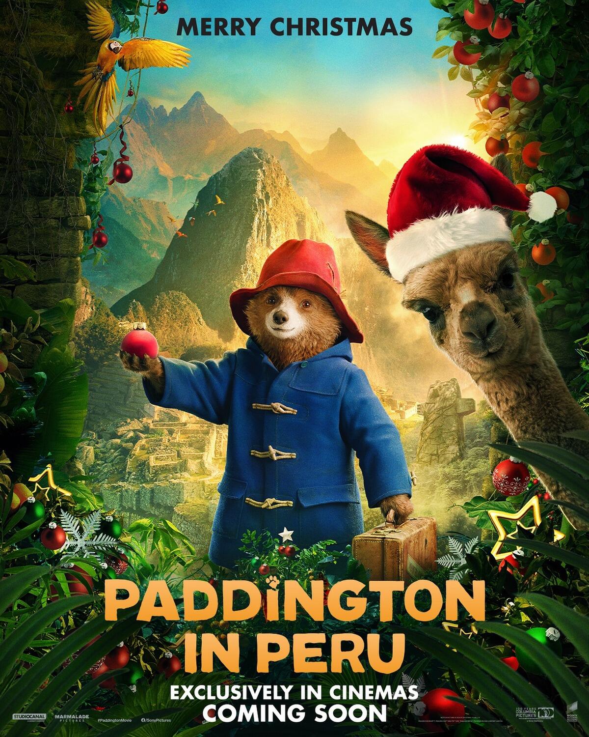 A whimsical movie poster for Paddington in Peru, featuring Paddington Bear in a blue coat and red hat, surrounded by lush greenery and an alpaca, with Christmas decorations.