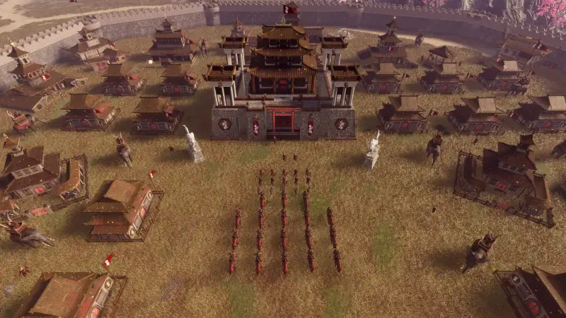 Aerial view of a detailed strategic landscape in the video game Eyes of War, showcasing a fortified central building surrounded by structured barracks and troops arranged in formation.