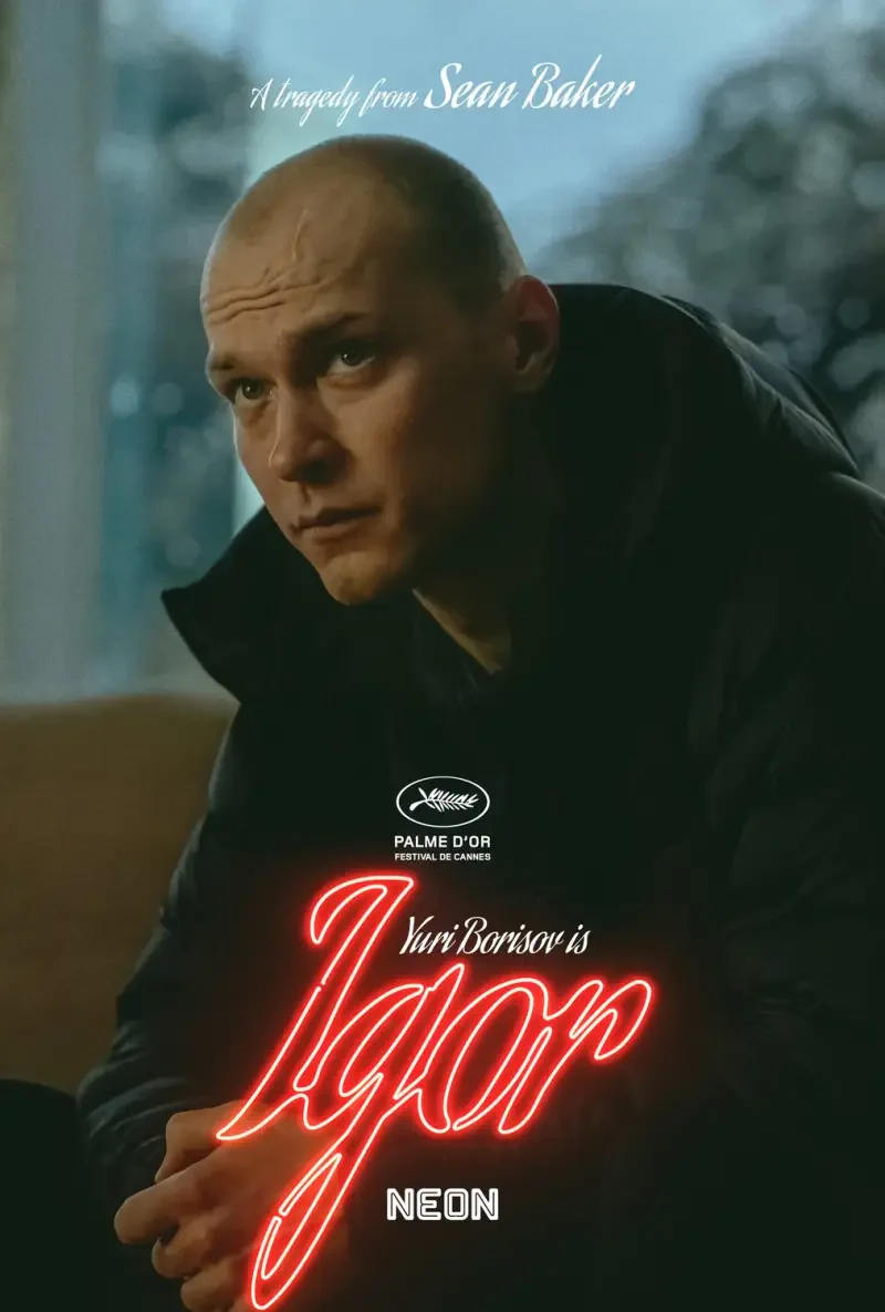 A promotional poster for the movie Anora (2024) featuring actor Yurii Borisov as Igor, directed by Sean Baker, highlighted by a dramatic expression and neon lettering.