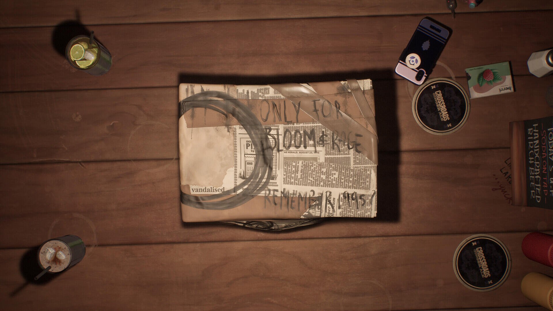 An overhead view of a table featuring a notebook titled Lost Records: Bloom & Rage, surrounded by various objects, including cans and cards, hinting at a creative atmosphere.