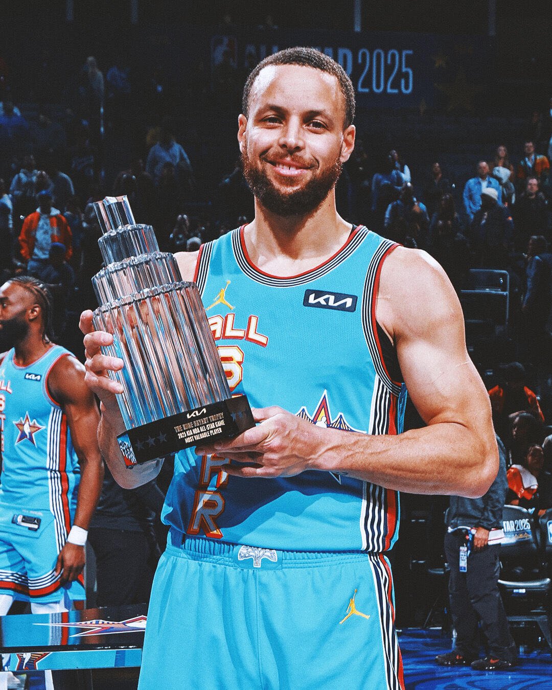 Stephen Curry celebrates his victory at the NBA All-Star Game, holding the trophy in his hands while wearing the team's vibrant uniform.