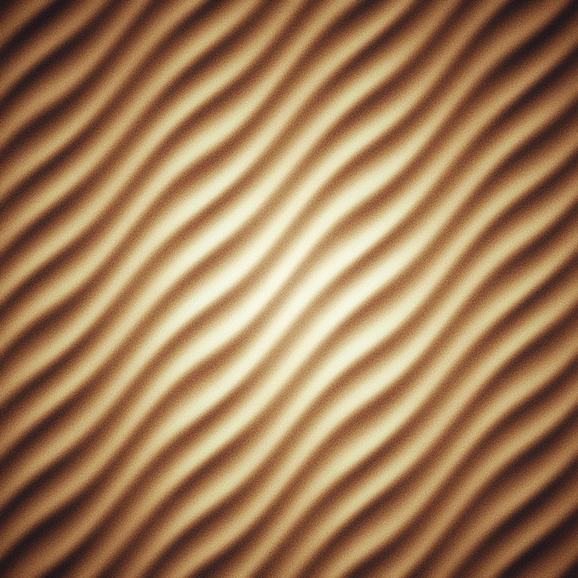 Golden sand dunes form a flowing raster pattern, capturing the natural texture of a desert landscape.