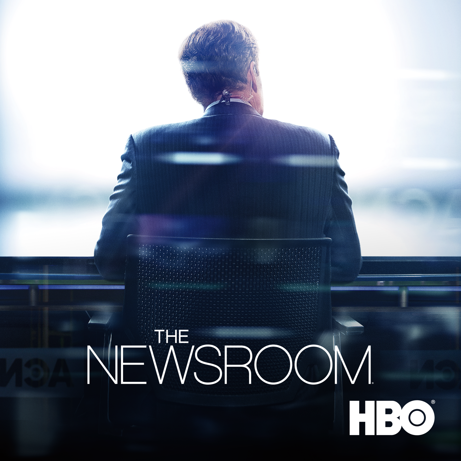 Back view of a news anchor at a broadcast desk in a bright studio with The Newsroom (2012) TV show title and HBO logo.