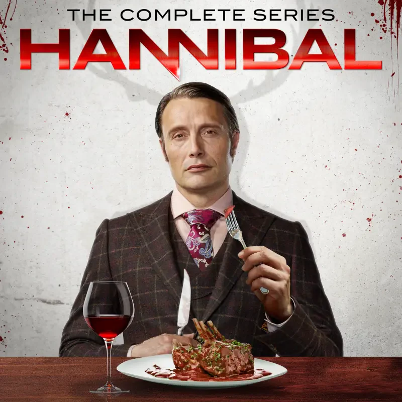 Hannibal TV show cover: a well-dressed man in a suit sits at a table with a plate of meat and a glass of red wine, holding a fork beneath the title HANNIBAL.