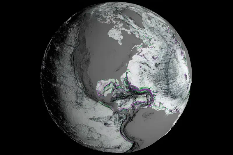 NASA satellite view of Earth showing North and South America with cloud patterns across the oceans, rendered in grayscale against the blackness of space.