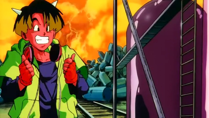 Saike Demon from Dragon Ball Z anime gives a thumbs-up with a colorful, humorous expression against a vibrant fiery and industrial background.